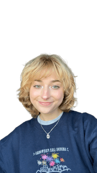 a woman wearing a sweatshirt with a flower on it